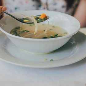 A bowl of soup on a table.